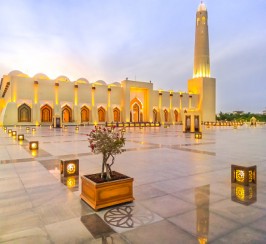 Lights illuminate the mosque's courtyard from the outside