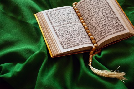 The book of God on a green silk top